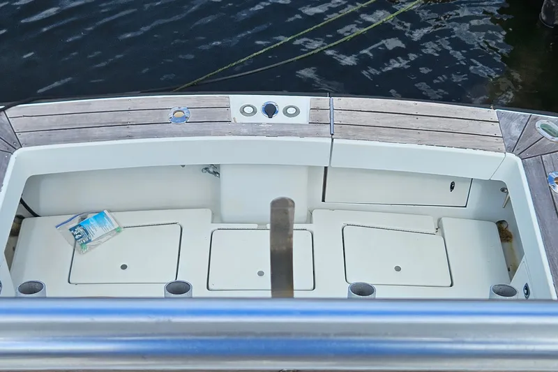 Slide: The Image of 1987 Rampage 28 Sportsman boat helm with steering wheel and controls, dockside view. - 20