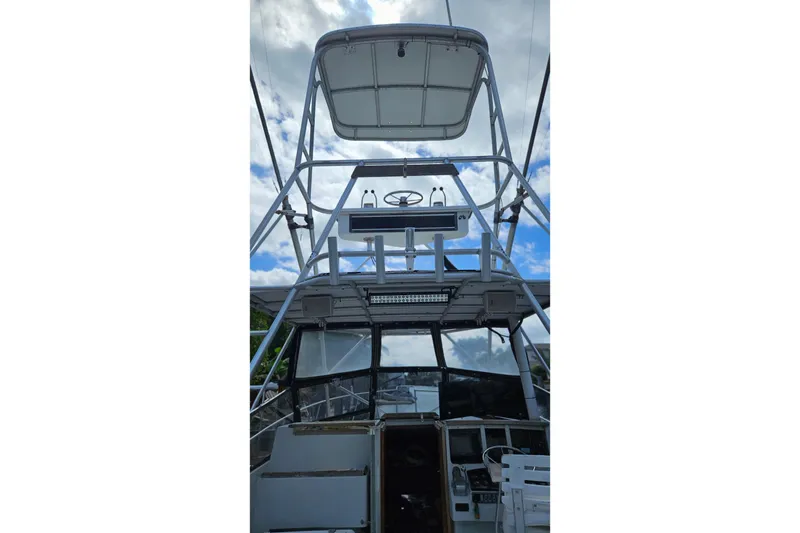 Slide: The Image of 1987 Rampage 28 Sportsman docked, with a view of the marina and nearby boats. - 23