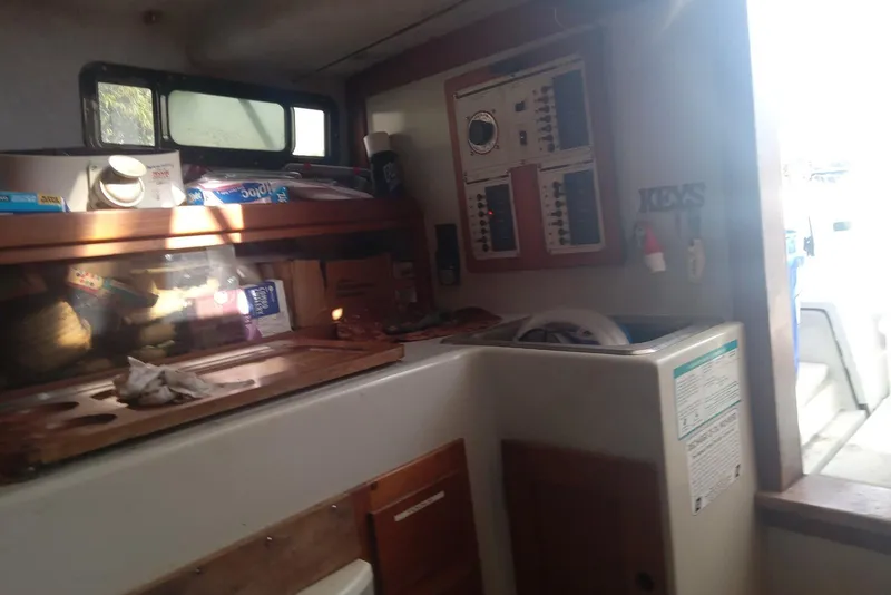 Slide: The Image of Interior of 1987 Rampage 28 Sportsman boat with fishing gear and storage. - 25