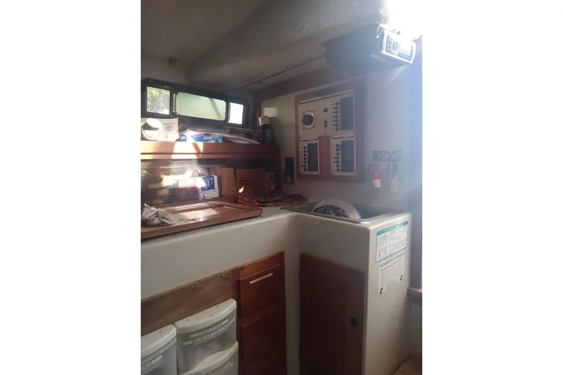 Slide: The Image of 1987 Rampage 28 Sportsman boat interior with sink and storage. - 28
