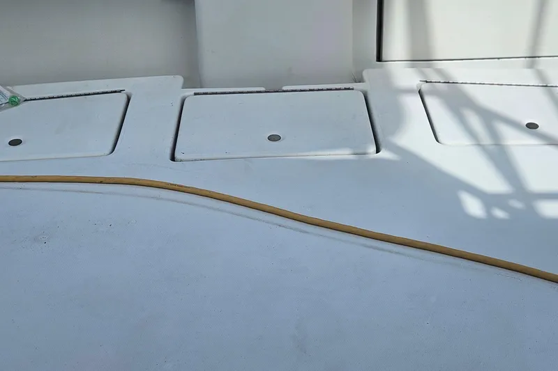 Slide: The Image of Open storage compartment on 1987 Rampage 28 Sportsman boat with ropes and bottles. - 33