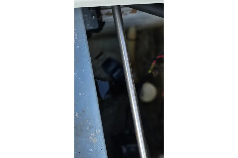 Slide: The Image of 1987 Rampage 28 Sportsman boat compartment with battery and yellow container. - 36