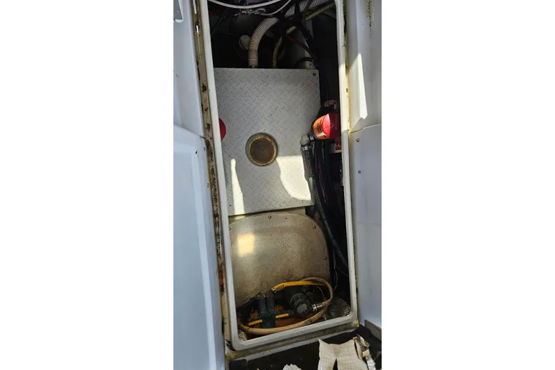 Slide: The Image of 1987 Rampage 28 Sportsman engine compartment with wiring and hoses visible. - 40