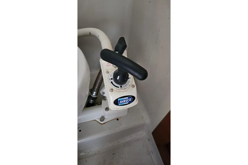 Slide: The Image of 1987 Rampage 28 Sportsman boat interior with clear skies and marina view. - 43