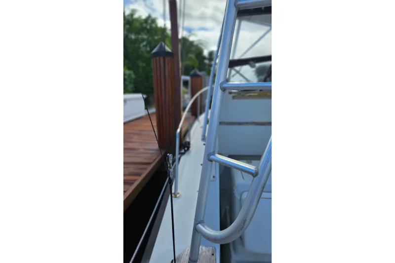 Slide: The Image of 1987 Rampage 28 Sportsman boat docked under a cloudy sky. - 6