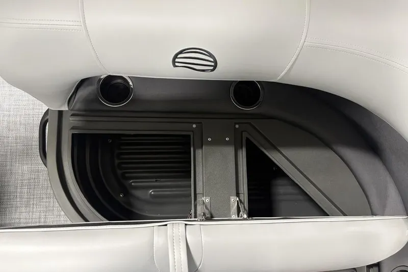 Slide: The Image of 2026 Sun Tracker Party Barge 18 DLX interior storage compartment with cup holders. - 21