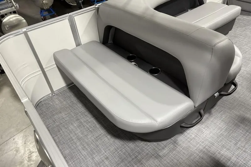 Slide: The Image of 2026 Sun Tracker Party Barge 18 DLX interior with gray seating and cup holders. - 26