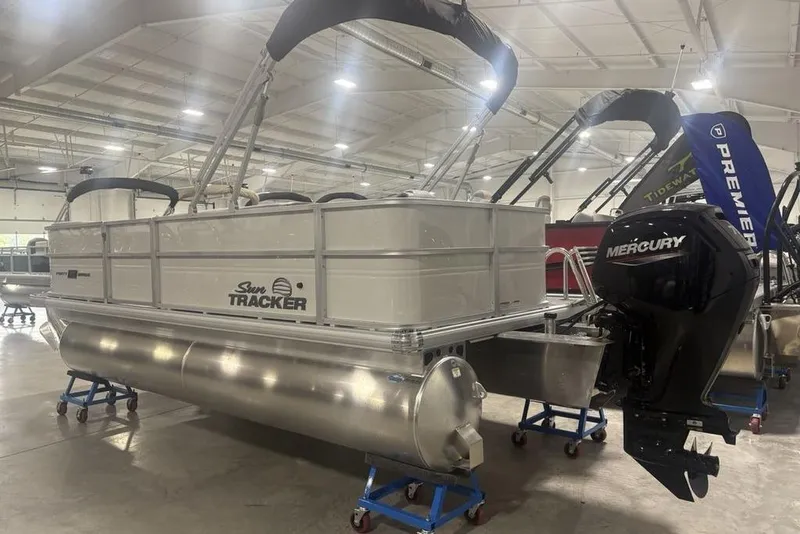Slide: The Image of 2026 Sun Tracker Party Barge 18 DLX pontoon boat with Mercury engine in showroom. - 7