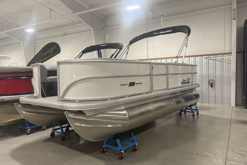Slide: The Image of 2026 Sun Tracker Party Barge 18 DLX pontoon boat displayed indoors. - 9