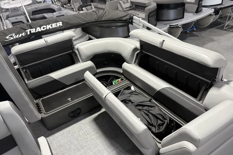 Slide: The Image of 2026 Sun Tracker PARTY BARGE® 20 DLX interior with open storage compartments and seating. - 21
