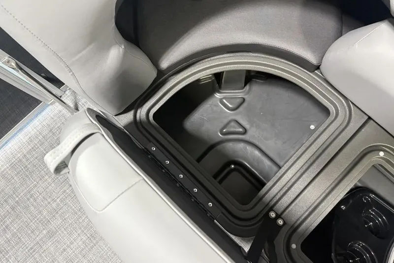 Slide: The Image of 2026 Sun Tracker PARTY BARGE® 20 DLX storage compartment with gray seating. - 5