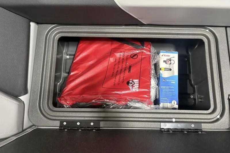 Slide: The Image of Storage compartment in 2026 Sun Tracker Party Barge 22 XP3 with safety equipment. - 13