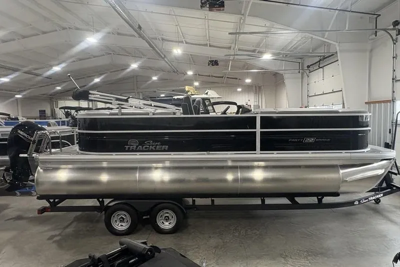 Slide: The Image of 2026 Sun Tracker Party Barge 22 XP3 pontoon boat in a showroom. - 4