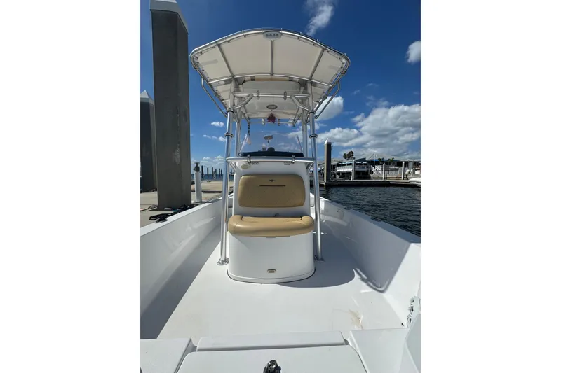 Slide: The Image of 2021 Sportsman Tournament 234 SBX Bay Boat docked under clear blue sky. - 10