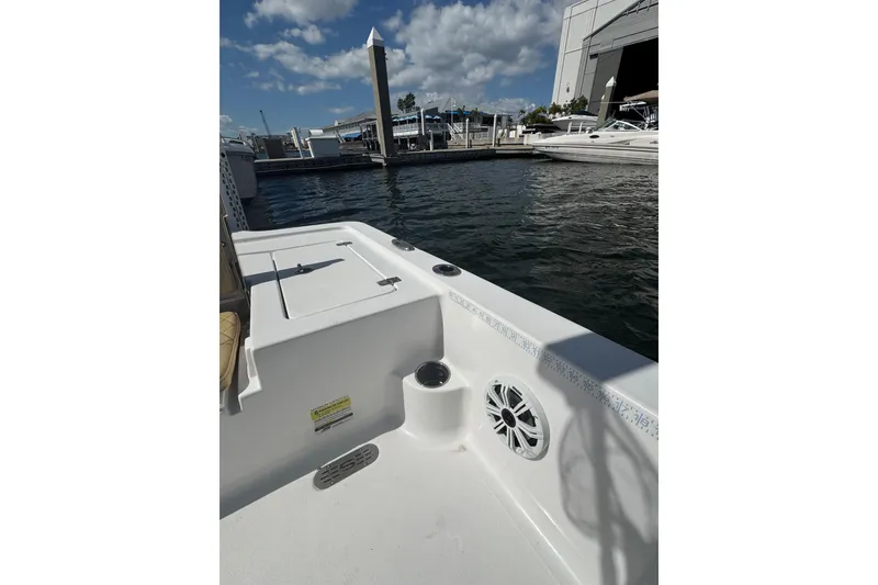 Slide: The Image of 2021 Sportsman Tournament 234 SBX Bay Boat docked at marina under blue sky. - 14