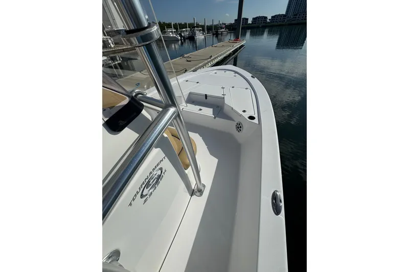 Slide: The Image of 2021 Sportsman Tournament 234 SBX Bay Boat docked at marina, sleek design, calm waters. - 19