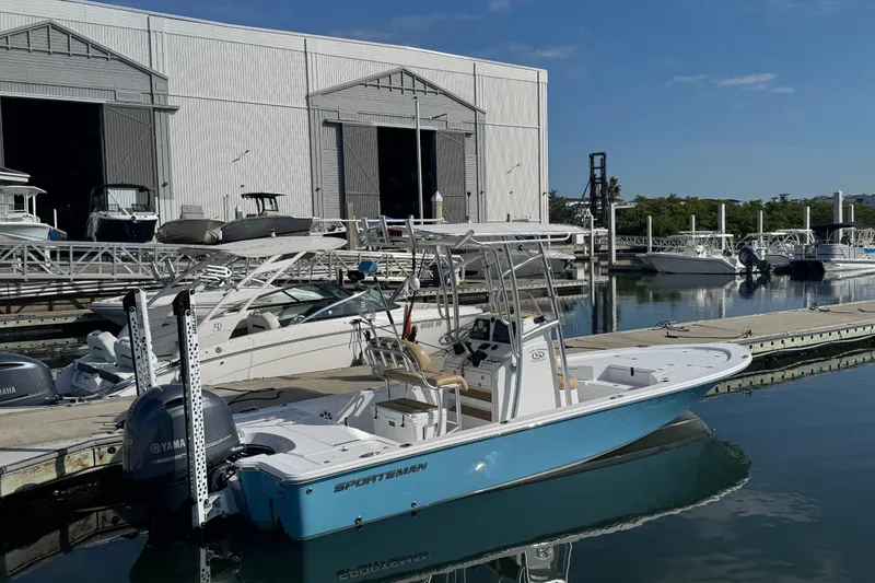 Slide: The Image of 2021 Sportsman Tournament 234 SBX Bay Boat docked at marina with clear blue sky. - 2
