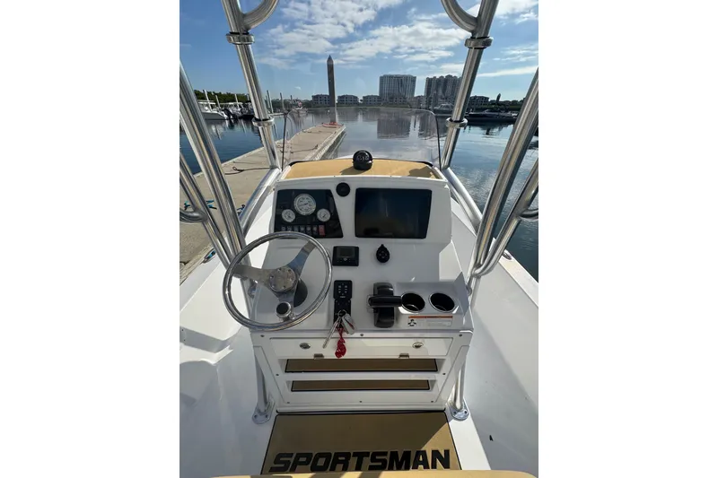 Slide: The Image of 2021 Sportsman Tournament 234 SBX Bay Boat dashboard with steering wheel and controls at marina. - 21