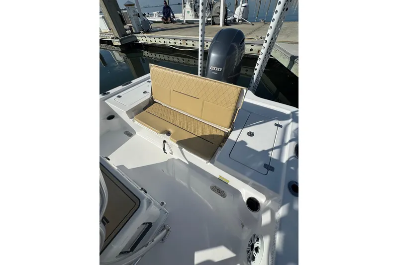 Slide: The Image of 2021 Sportsman Tournament 234 SBX Bay Boat with tan seating, docked at marina. - 22