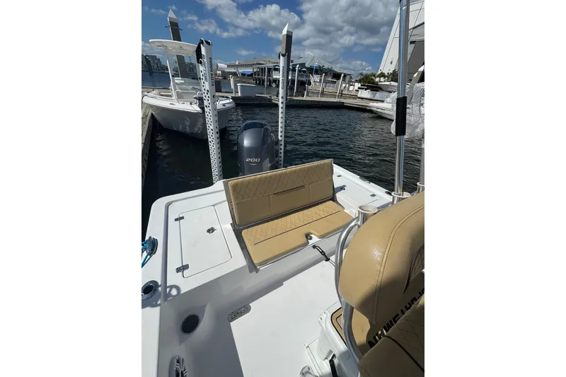 Slide: The Image of 2021 Sportsman Tournament 234 SBX Bay Boat docked, featuring tan seating and Yamaha 200 engine. - 5
