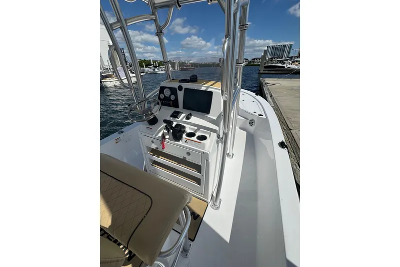 Slide: The Image of 2021 Sportsman Tournament 234 SBX Bay Boat interior with helm, controls, and seating. - 6