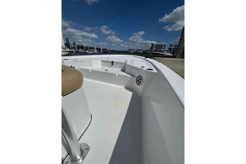 Slide: The Image of 2021 Sportsman Tournament 234 SBX Bay Boat deck under clear blue sky. - 8