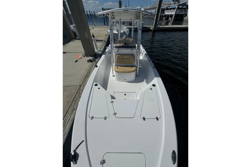 Slide: The Image of 2021 Sportsman Tournament 234 SBX Bay Boat docked at marina, showcasing sleek design. - 9