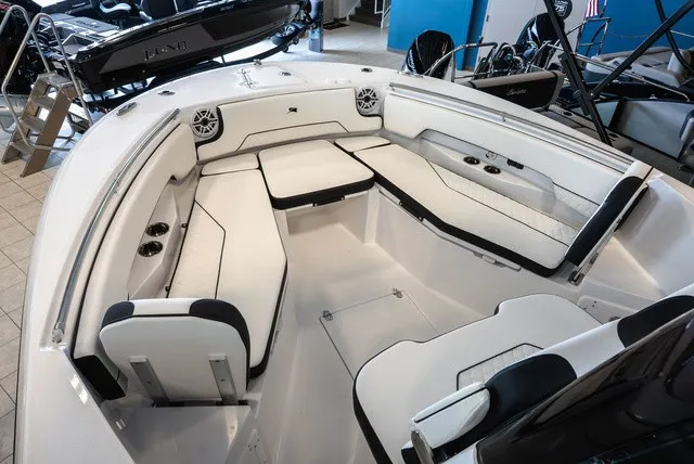Slide: The Image of The image shows the cockpit of a 2026 Stingray 253 CC boat with white upholstery and speakers. - 23