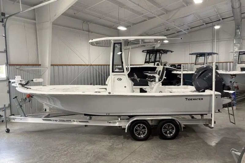 The Image of 2026 Tidewater 2210 Carolina Bay boat on trailer in indoor showroom. - 0