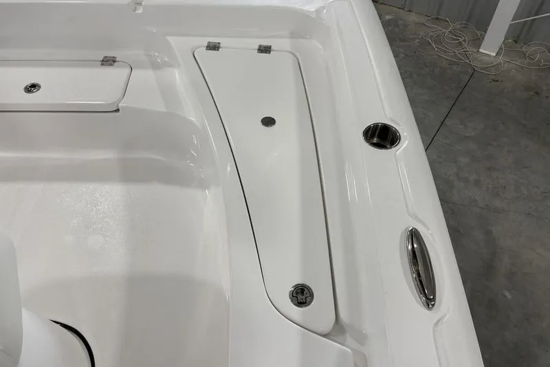 Slide: The Image of 2026 Tidewater 2210 Carolina Bay boat interior with sleek white design and storage compartment. - 13