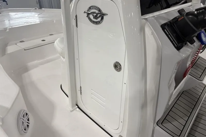 Slide: The Image of 2026 Tidewater 2210 Carolina Bay boat interior with storage compartment and cup holder. - 14