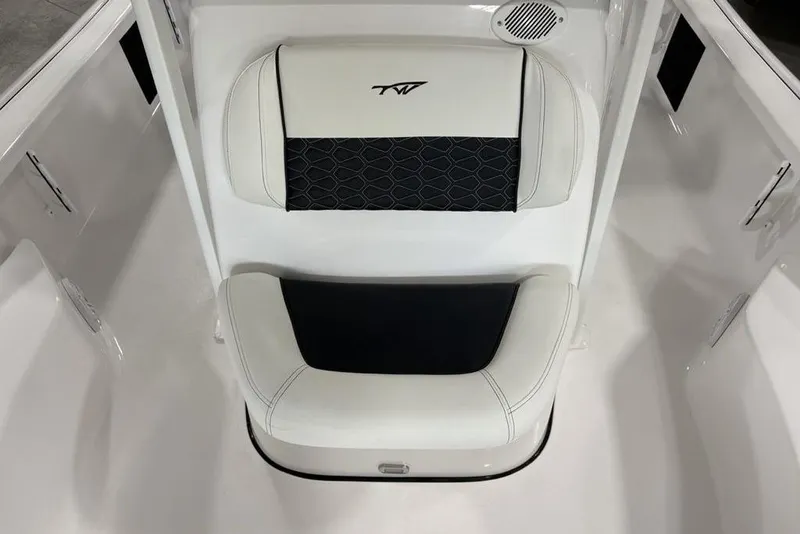 Slide: The Image of 2026 Tidewater 2210 Carolina Bay boat interior with storage compartment and cup holder. - 16
