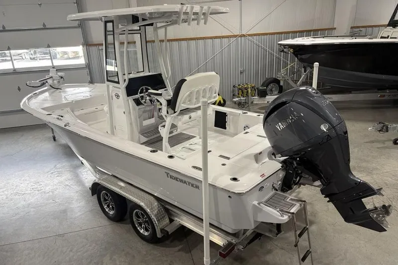 Slide: The Image of 2026 Tidewater 2210 Carolina Bay boat in showroom, featuring Yamaha outboard motor. - 2