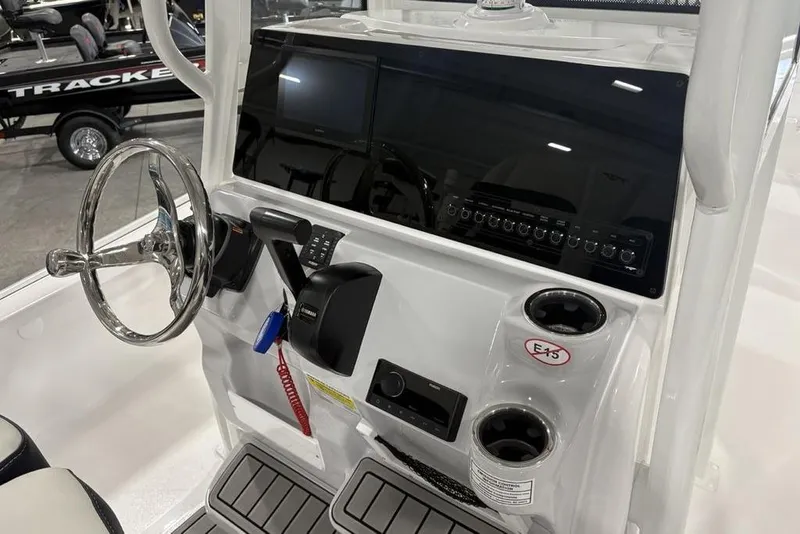 Slide: The Image of 2026 Tidewater 2210 Carolina Bay boat console with control panel and storage compartment. - 23