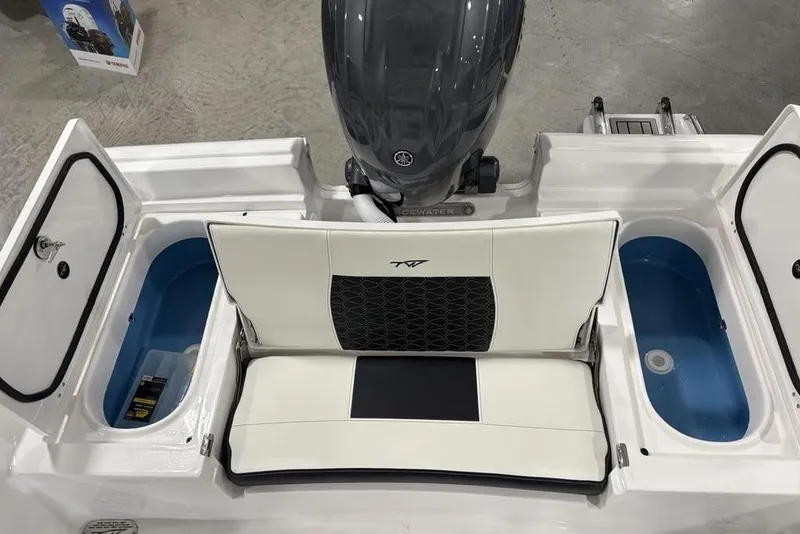 Slide: The Image of 2026 Tidewater 2210 Carolina Bay boat's rear deck with motor and storage compartments. - 31
