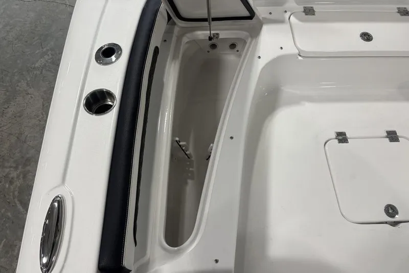 Slide: The Image of 2026 Tidewater 2300 Carolina Bay boat interior with storage compartments and cup holders. - 12