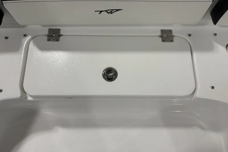 Slide: The Image of 2026 Tidewater 2300 Carolina Bay boat storage compartment with secure latch and hinges. - 14