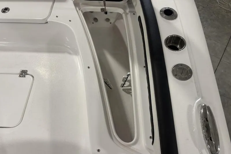 Slide: The Image of 2026 Tidewater 2300 Carolina Bay boat interior with storage compartment and cup holders. - 17