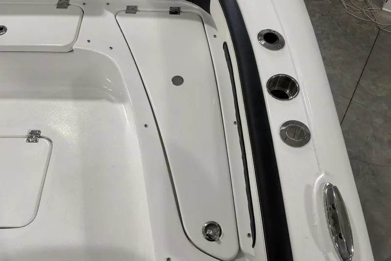 Slide: The Image of 2026 Tidewater 2300 Carolina Bay boat deck with storage compartments and cup holders. - 18