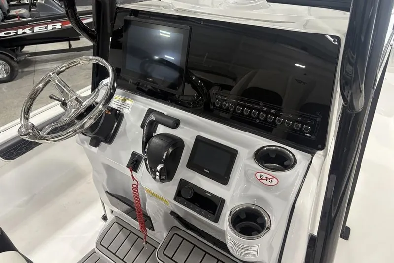 Slide: The Image of 2026 Tidewater 2300 Carolina Bay boat console with steering wheel and electronic controls. - 20