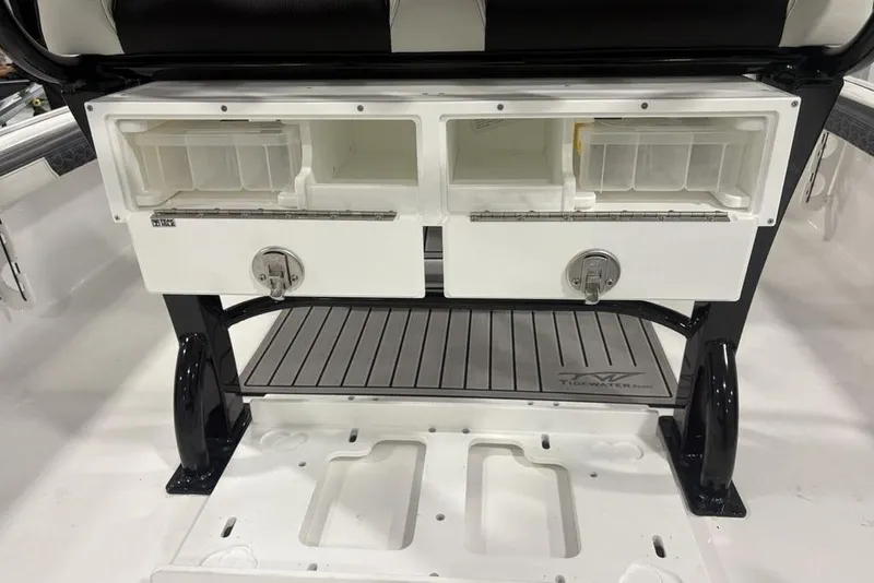 Slide: The Image of 2026 Tidewater 2300 Carolina Bay boat storage compartments with secure latches and organized interior. - 33