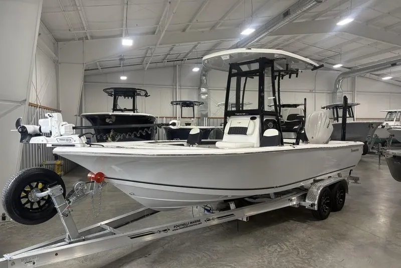 Slide: The Image of 2026 Tidewater 2300 Carolina Bay boat on trailer in indoor showroom. - 4