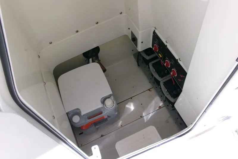 Slide: The Image of 2009 Hydra-Sports 2500 CC boat interior with storage compartment and battery switches. - 12
