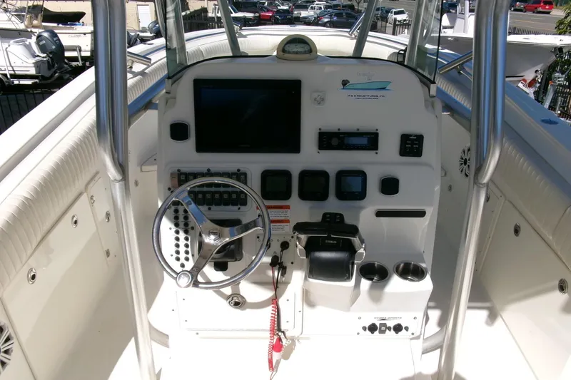 Slide: The Image of 2009 Hydra-Sports 2500 CC boat console with steering wheel and navigation controls. - 13
