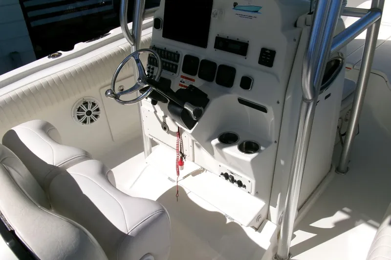 Slide: The Image of 2009 Hydra-Sports 2500 CC boat cockpit with steering wheel and control panel. - 16