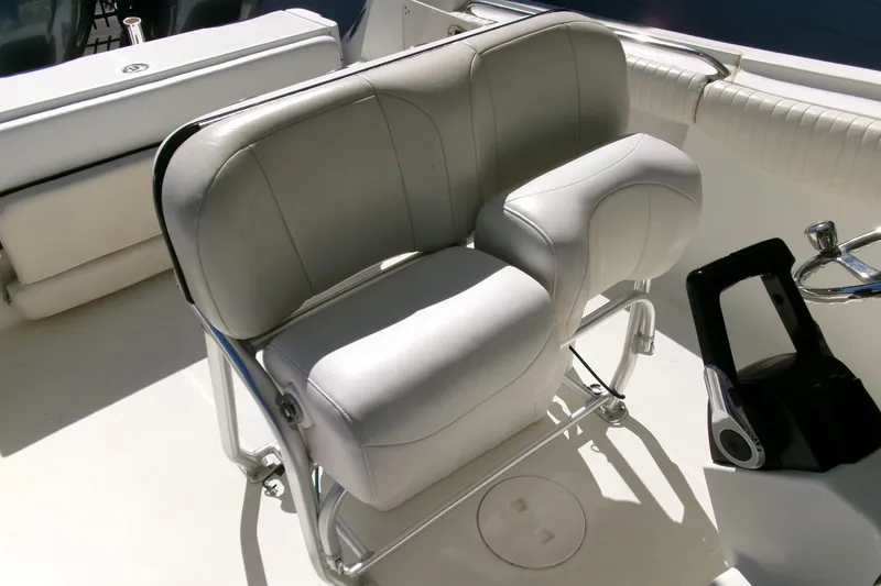 Slide: The Image of 2009 Hydra-Sports 2500 CC boat seat with white cushioned upholstery and metal frame. - 17