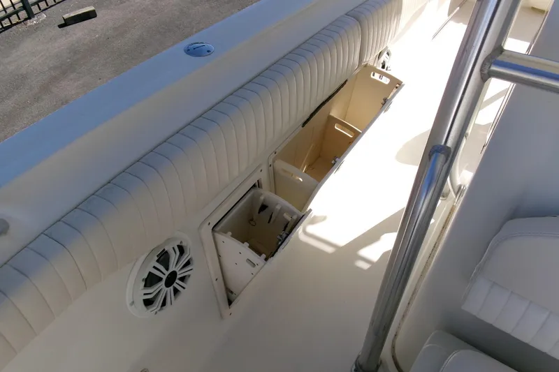 Slide: The Image of 2009 Hydra-Sports 2500 CC boat interior with open storage compartments and speaker. - 21