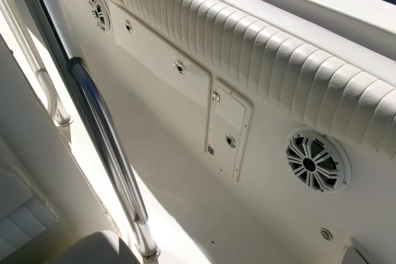 Slide: The Image of Interior view of a 2009 Hydra-Sports 2500 CC boat, featuring speakers and cushioned seating. - 22