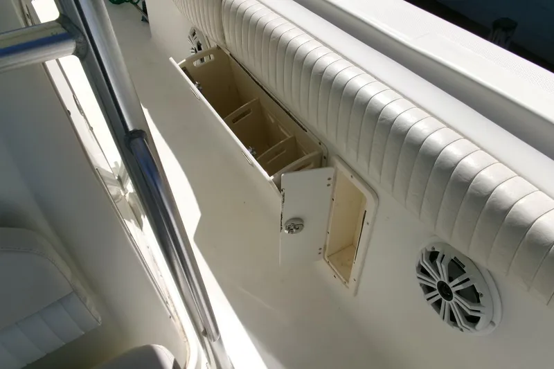 Slide: The Image of 2009 Hydra-Sports 2500 CC boat interior with storage compartment and speaker. - 23
