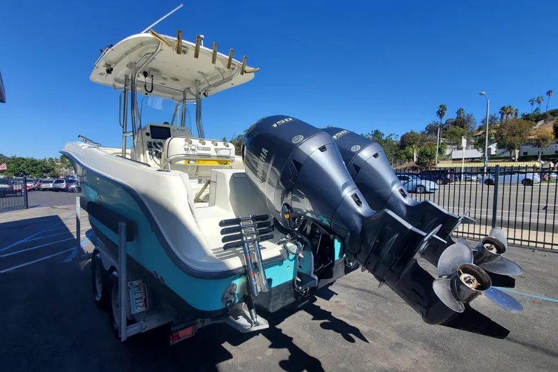 Slide: The Image of 2009 Hydra-Sports 2500 CC boat with dual outboard engines, parked outdoors under clear blue sky. - 3